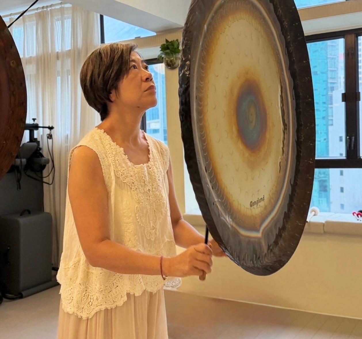 Gong workshop instructor playing a gong